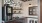 Coffee station at Delray Cafe, featuring modern decor, cream and sugar packets, as well as decorative signs. 